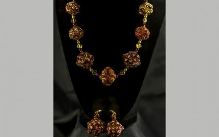 18” Necklace with Earrings.  The necklace consists of 7, 3 dimensional beaded beads 3/4 to 1” in diameter made of glass beads in gold, orange, purple and lime green. By Patricia Hinga $200.00